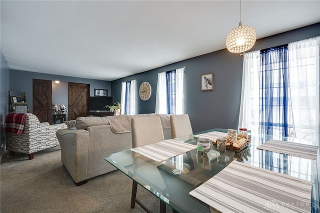 carpeted dining space featuring a healthy amount of sunlight