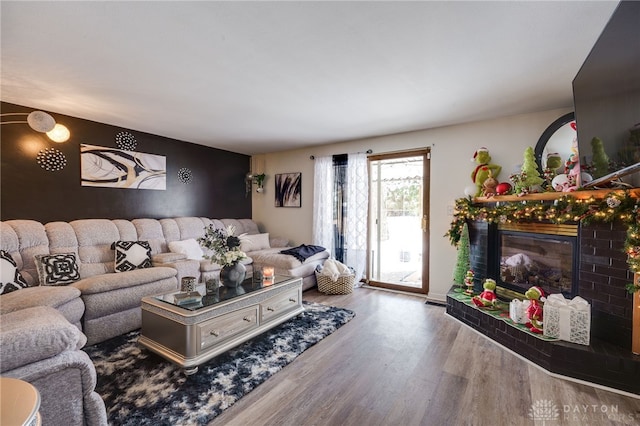 living room with a fireplace and light hardwood / wood-style floors