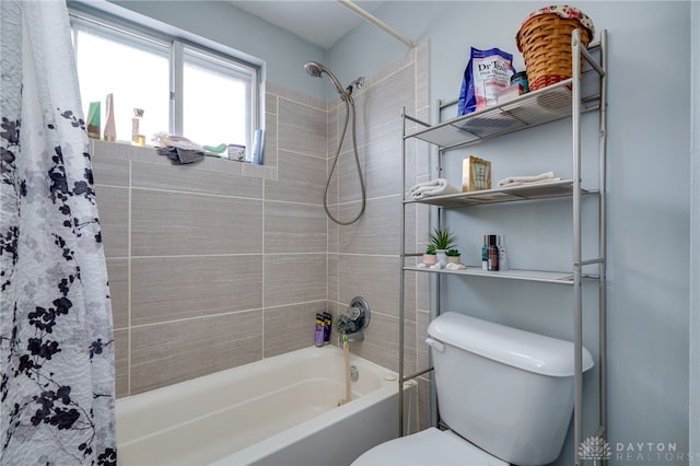 bathroom featuring shower / bathtub combination with curtain and toilet