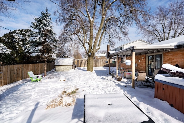 yard layered in snow featuring a hot tub