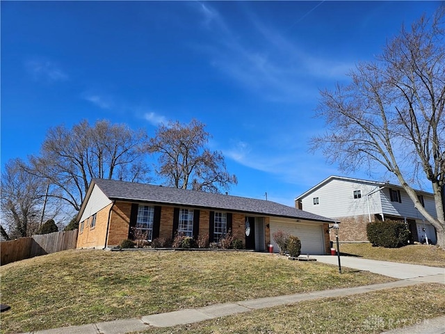 view of front of house featuring a garage and a front lawn