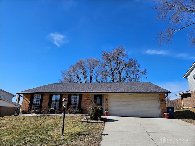 single story home featuring a garage and a front lawn