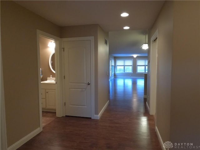 hallway with sink and dark wood-type flooring