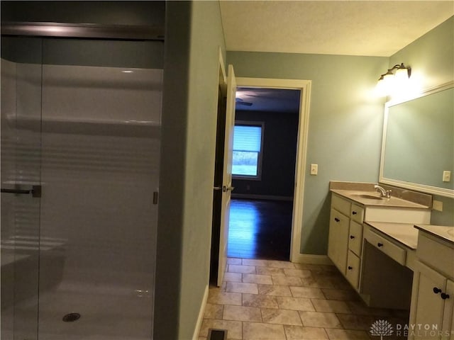 bathroom featuring tile patterned floors, vanity, and walk in shower