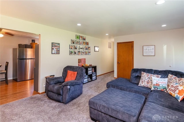 carpeted living area featuring visible vents, recessed lighting, a ceiling fan, and baseboards