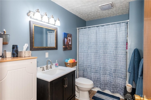 full bath with tile patterned flooring, visible vents, toilet, vanity, and a textured ceiling