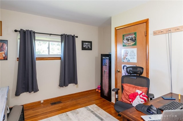 interior space with visible vents and wood finished floors