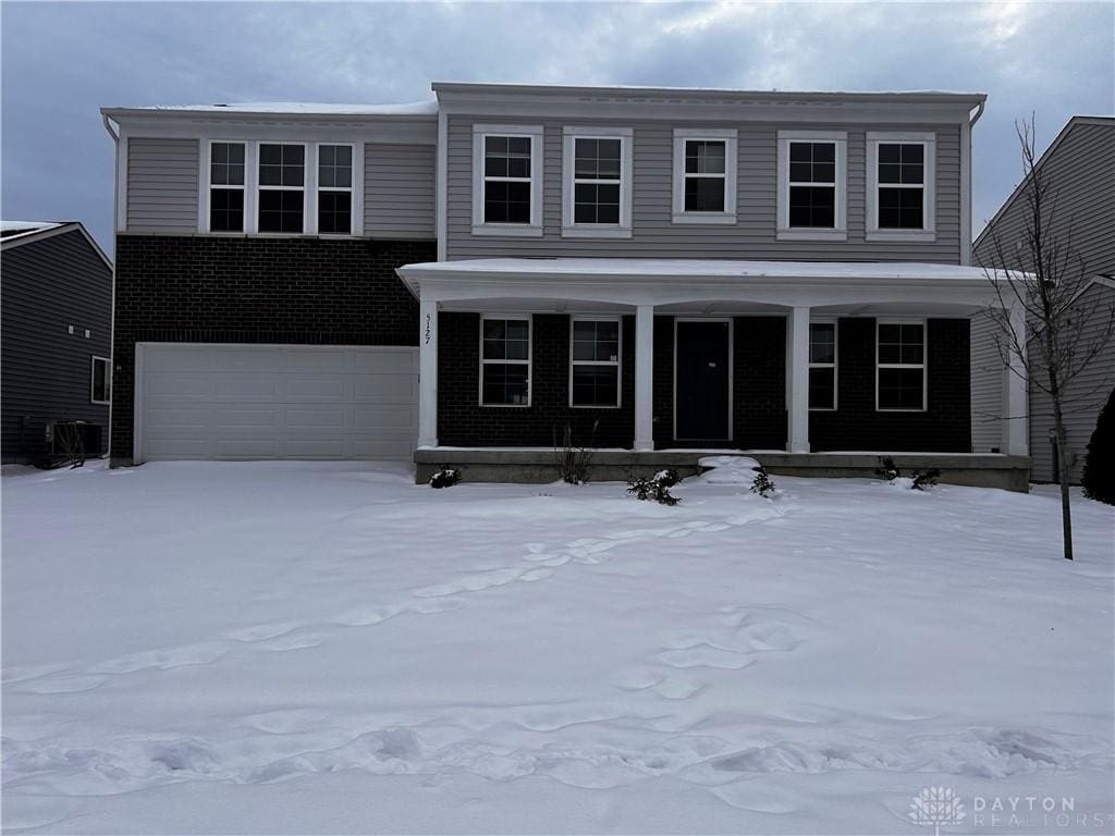 view of front of property with covered porch and a garage