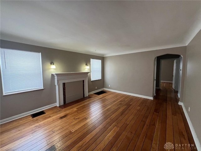 unfurnished living room with wood-type flooring