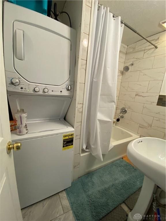 bathroom featuring stacked washer and dryer and shower / bath combo