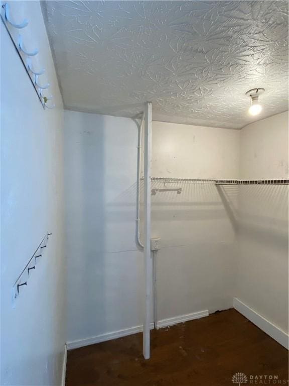 basement with dark hardwood / wood-style flooring and a textured ceiling