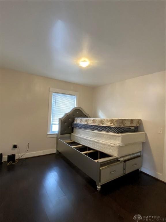 unfurnished bedroom with dark hardwood / wood-style floors