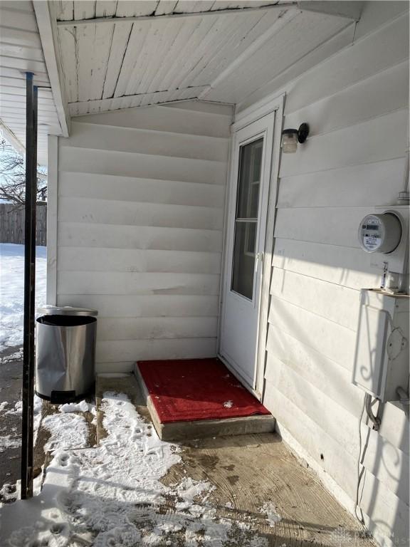 view of snow covered property entrance