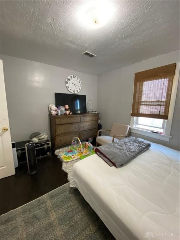 bedroom featuring a textured ceiling