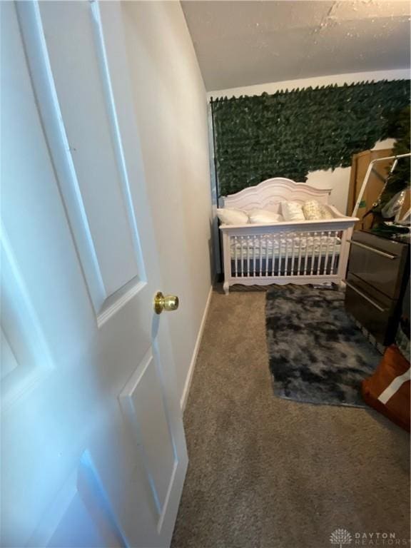 carpeted bedroom with lofted ceiling