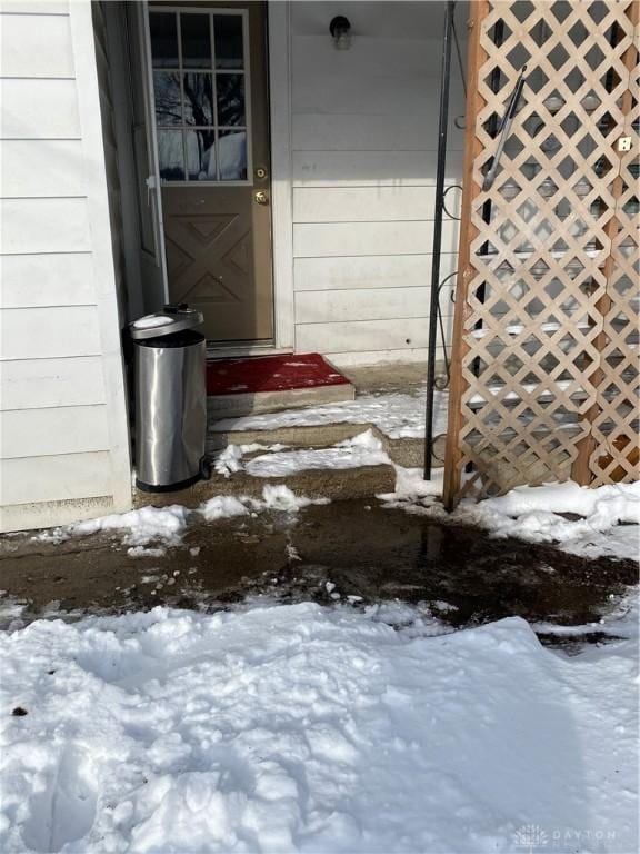 view of snow covered property entrance