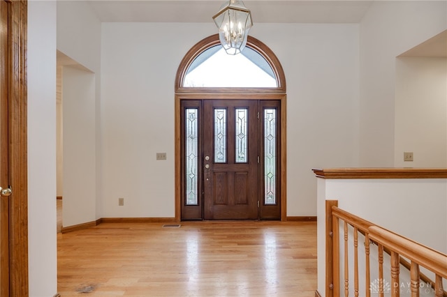 entryway featuring light hardwood / wood-style flooring and a notable chandelier