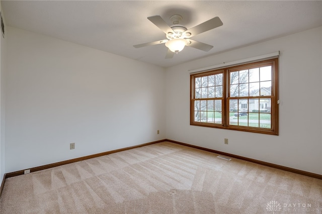 unfurnished room with ceiling fan and light colored carpet