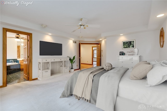 carpeted bedroom featuring connected bathroom and ceiling fan