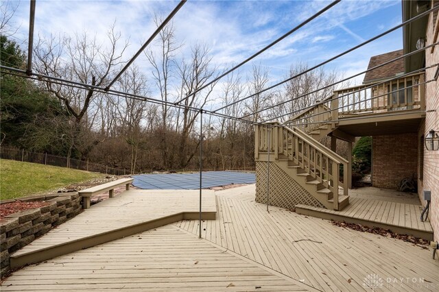 wooden deck featuring a covered pool