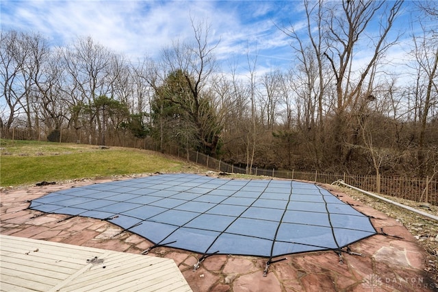 view of swimming pool with a patio and a yard