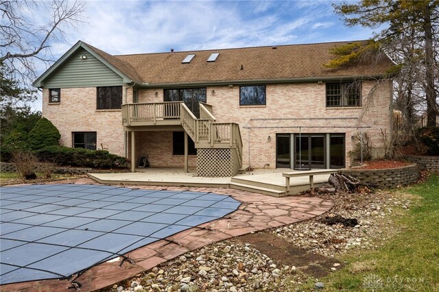 back of house with a patio area and a swimming pool side deck