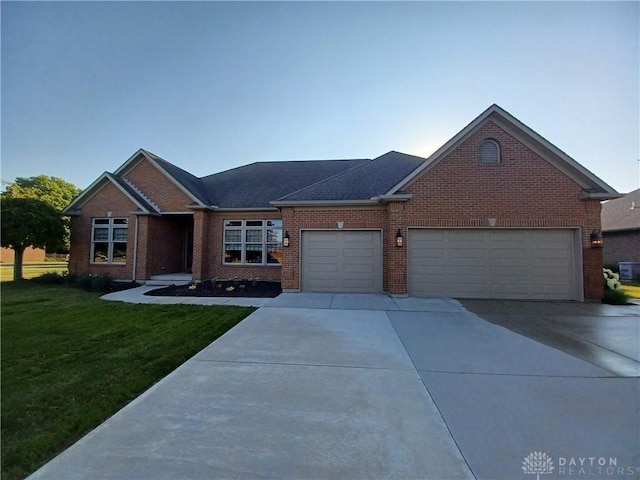 view of front of house featuring a front yard and a garage