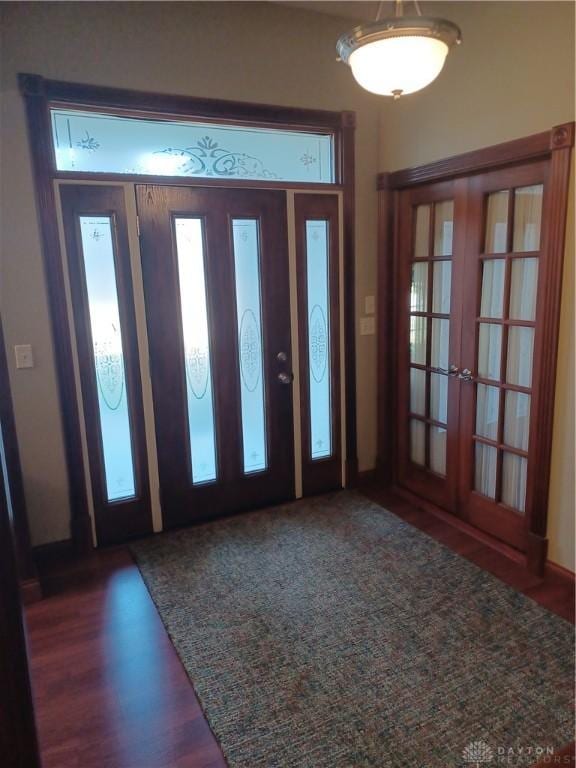 foyer entrance with dark hardwood / wood-style flooring and french doors