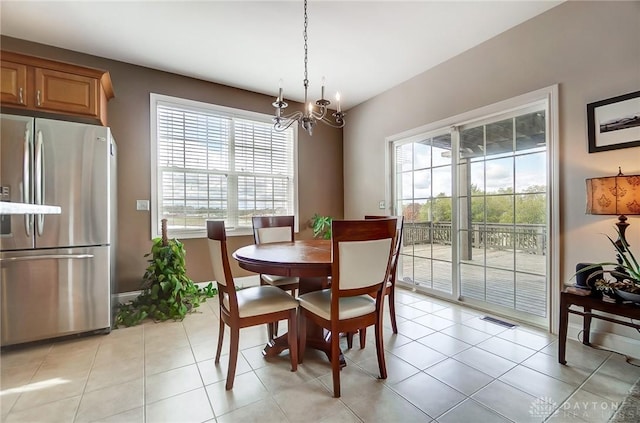 tiled dining area with a notable chandelier