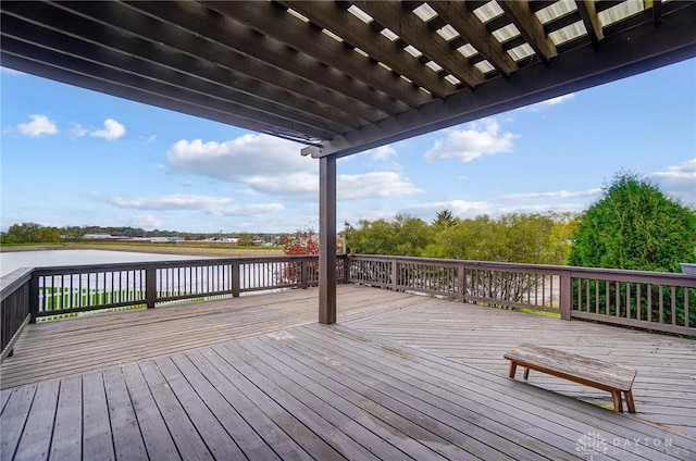 wooden terrace featuring a water view