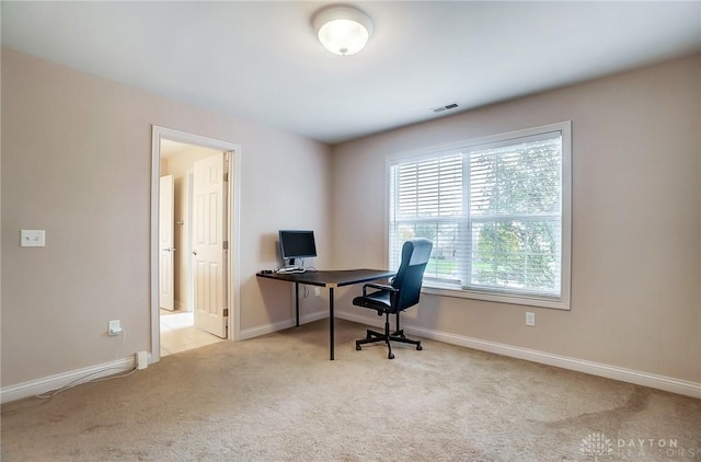 office area featuring light carpet