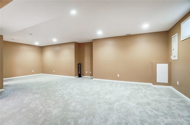 unfurnished room featuring light carpet