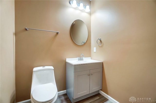 bathroom featuring hardwood / wood-style floors, vanity, and toilet