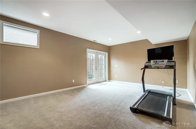 exercise area featuring carpet flooring and french doors