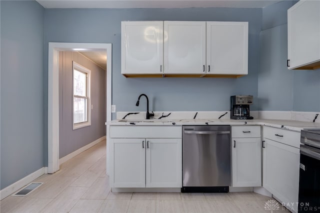 kitchen featuring sink, white cabinets, and dishwasher