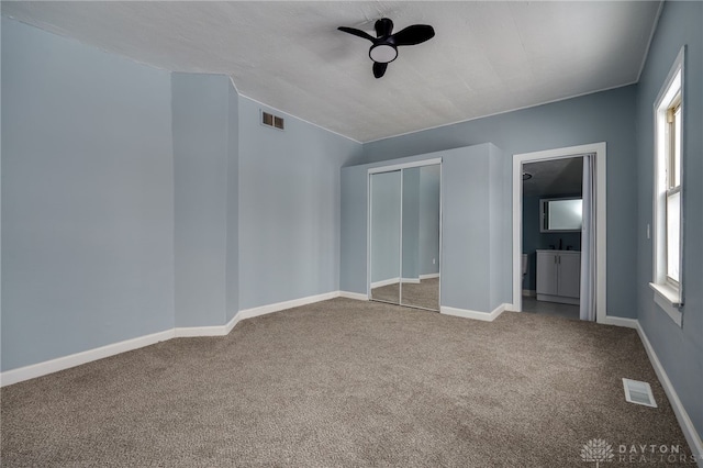 unfurnished bedroom featuring a closet and carpet