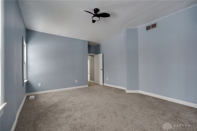 carpeted empty room featuring ceiling fan