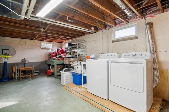 washroom with washing machine and clothes dryer and plenty of natural light