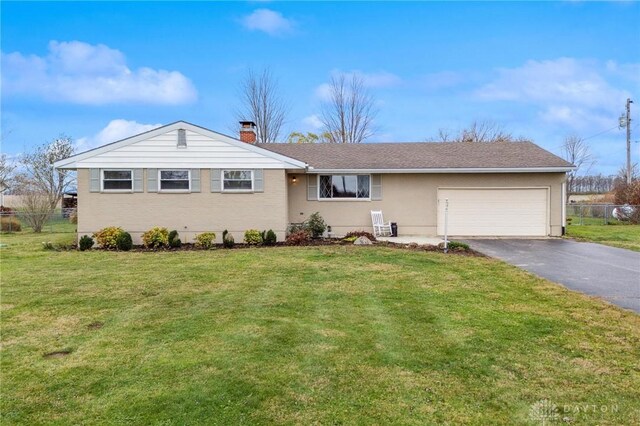 ranch-style home with a front yard and a garage