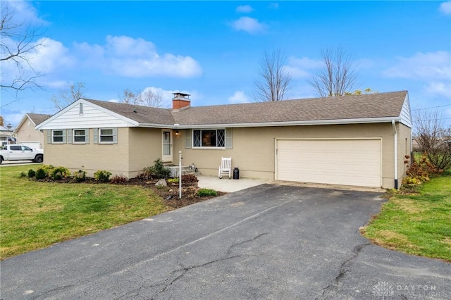 ranch-style home with a front lawn and a garage