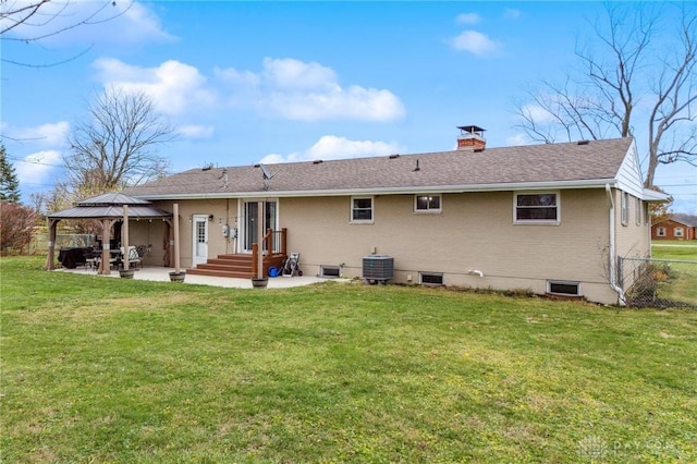 rear view of house with a gazebo, a patio area, central air condition unit, and a yard