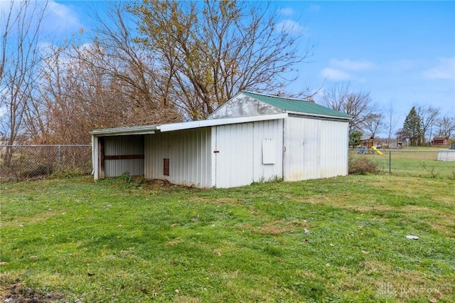 view of outdoor structure featuring a lawn