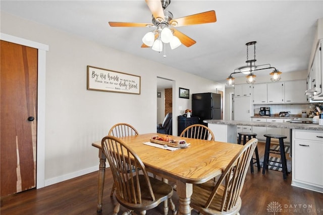 dining area featuring dark hardwood / wood-style floors and ceiling fan