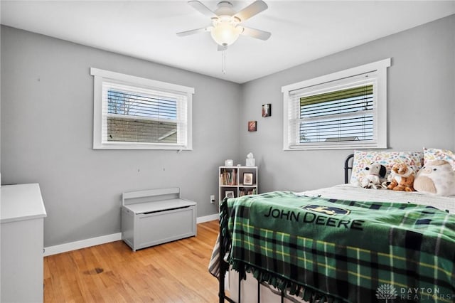 bedroom with ceiling fan and light hardwood / wood-style floors