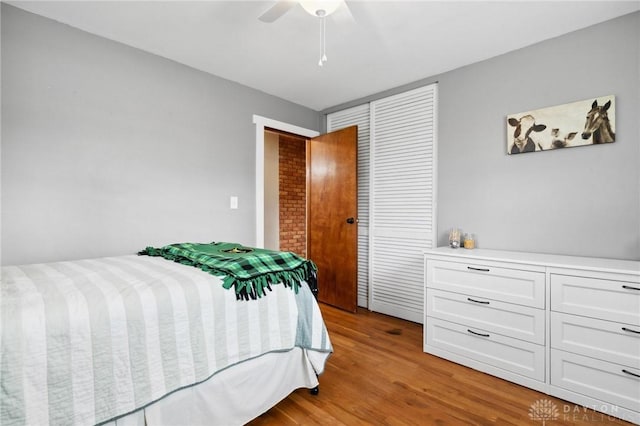 bedroom with a closet, ceiling fan, and light hardwood / wood-style flooring