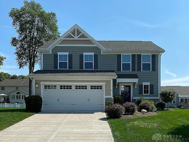 view of front of property featuring a front yard and a garage