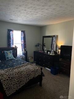 bedroom featuring carpet and a textured ceiling