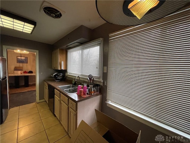 kitchen with light tile patterned flooring, sink, and black appliances