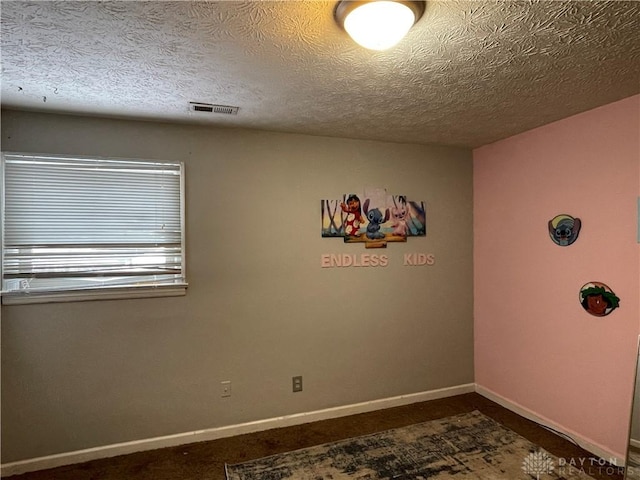 spare room featuring a textured ceiling