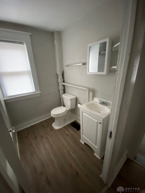 bathroom featuring hardwood / wood-style floors, vanity, and toilet